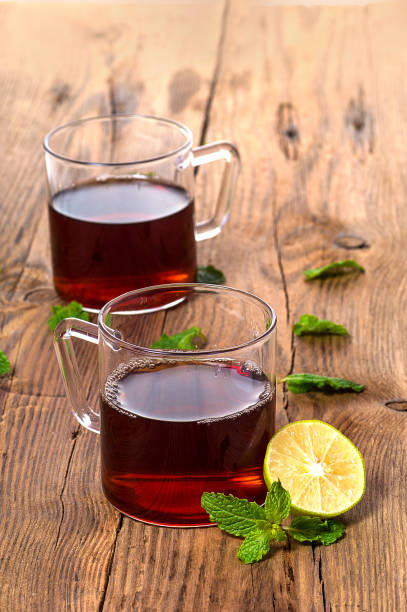 istock Cup of tea with ginger, lemon and mint on wooden table 1199012290