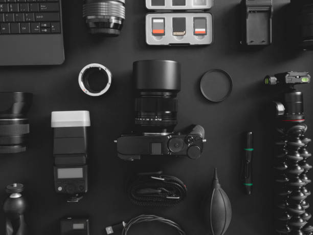 istock top view of work space photographer with digital camera, flash, cleaning kit, memory card, tripod and camera accessory on black table background 1199012800