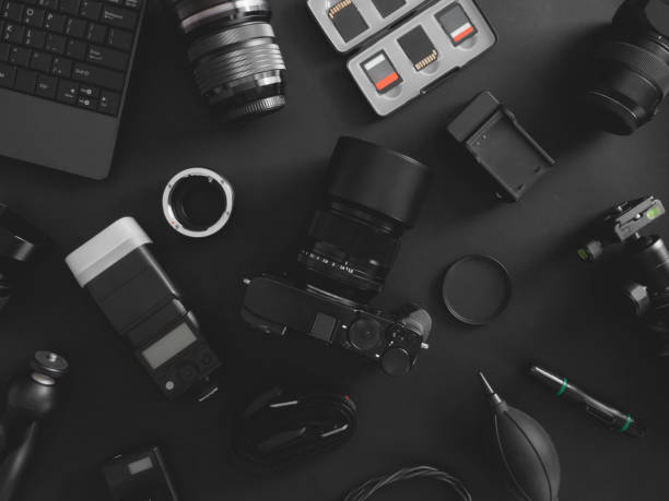 istock top view of work space photographer with digital camera, flash, cleaning kit, memory card, tripod and camera accessory on black table background 1199012810