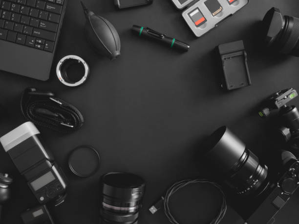 istock top view of work space photographer with digital camera, flash, cleaning kit, memory card, tripod and camera accessory on black table background 1199013331