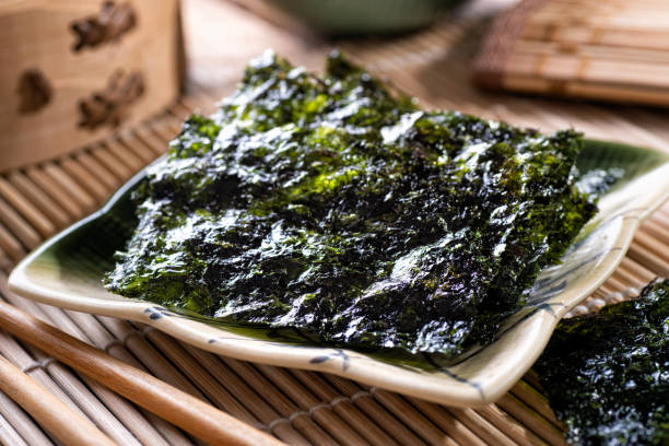 Toasted Seaweed Snacks Delicious toasted seaweed and sesame snacks. nori stock pictures, royalty-free photos & images