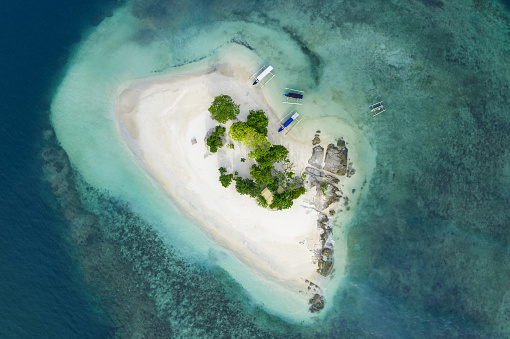 View from above, stunning aerial view of Gili Kedis with a beautiful white sand beach bathed by a turquoise and crystal clear water. Gili Kedis is a small island in southern Lombok, Indonesia.