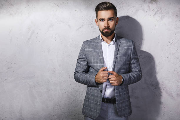 istock Handsome bearded man wearing gray checkered suit 1199016815