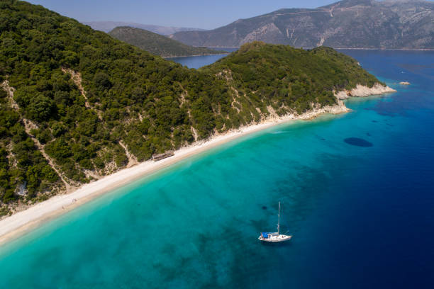 Beautiful beaches and coast of Ionian island Aerial view of wild coast of Ionian Islands in Greece. Sailboat anchored near beach. Ithaca island ithaca stock pictures, royalty-free photos & images