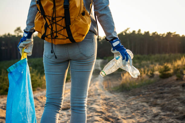 istock Volunteer cleaning nature from plastic pollution. 1199018065