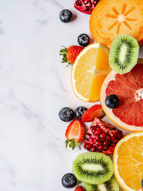 istock Multicolored seasonal healthy natural fruit composition with persimmon, blueberries, orange, kiwi, strawberries, grapefruit, pomegranate, orange slices. 1199020002