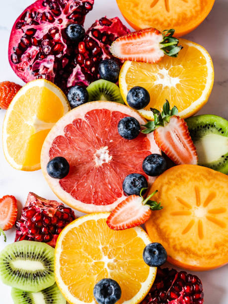 istock Multicolored seasonal healthy natural fruit composition with persimmon, blueberries, orange, kiwi, strawberries, grapefruit, pomegranate, orange slices. 1199020023