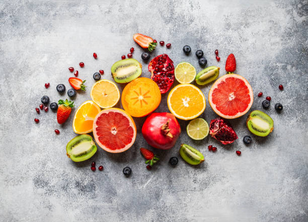 istock Multicolored seasonal healthy natural fruit composition with persimmon, blueberries, orange, kiwi, strawberries, grapefruit, pomegranate, orange slices. Top view 1199020034
