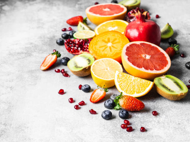 istock Multicolored seasonal healthy natural fruit composition with persimmon, blueberries, orange, kiwi, strawberries, grapefruit, pomegranate, orange slices. Copy space 1199020048