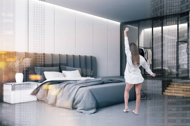 istock Woman in white bedroom with wardrobe 1199020230