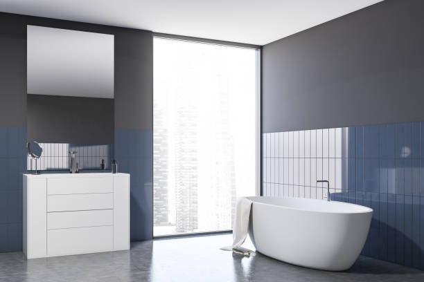 istock Gray and blue tile bathroom with tub and sink 1199020328