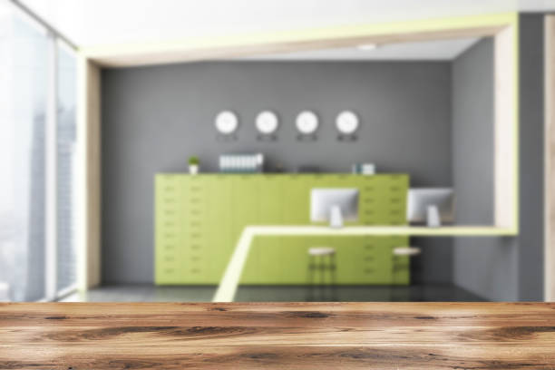 istock Table in gray and green office with clocks 1199020610