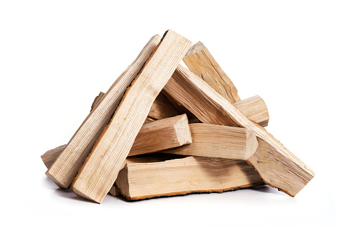 Pile of dry firewood isolated on a white background in close-up