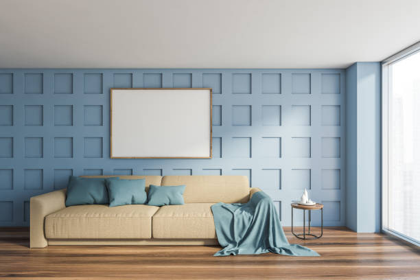 istock Blue living room with beige sofa and mockup poster 1199021634