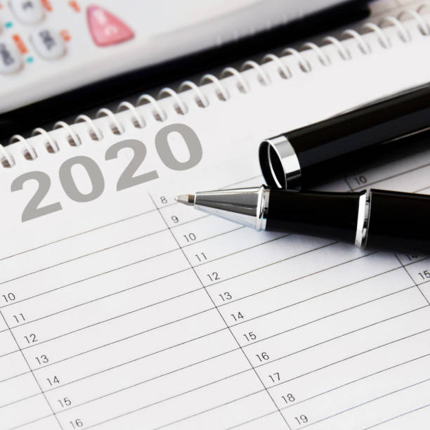 istock Calendar with pen and calculator background 2020 1199023335