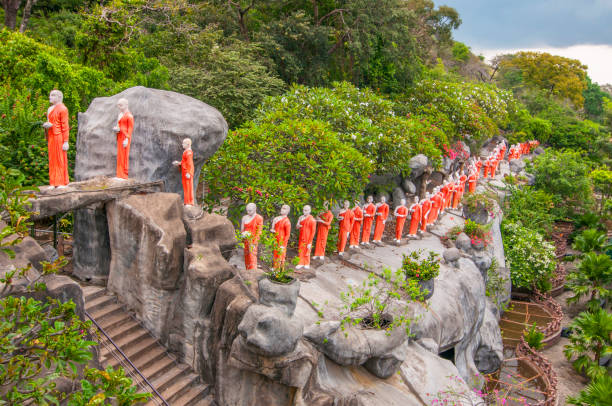 Procession of sculptured Buddhist monks Dambulla Caves Cultural Triangle Sri Lanka. Procession of sculptured Buddhist monks Dambulla Caves Cultural Triangle Sri Lanka. dambulla stock pictures, royalty-free photos & images