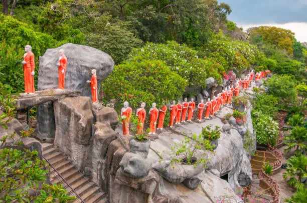 Photo of Procession of sculptured Buddhist monks Dambulla Caves Cultural Triangle Sri Lanka.