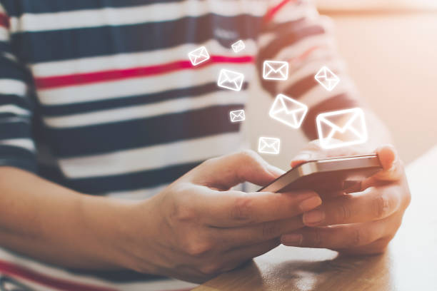 istock Close-up image of male hands using smartphone with icon envelope email. Contact us customer service or e-mail marketing concept 1199025969