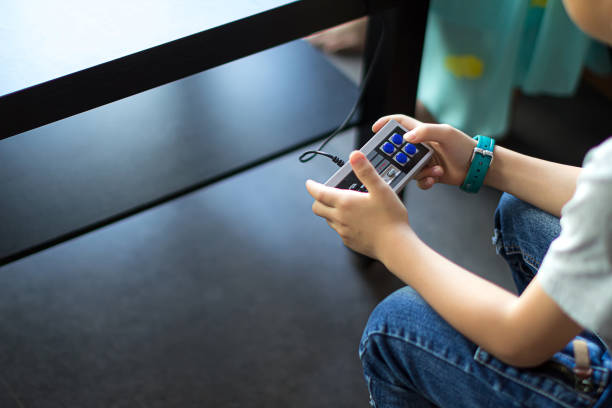 Close up of children hand holding console