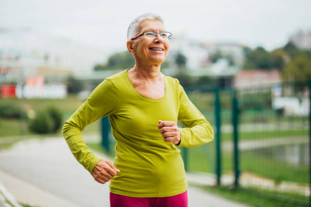 istock Fit older woman jogging alone 1199028624