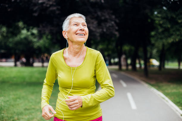 istock Charismatic older woman running alone 1199028634