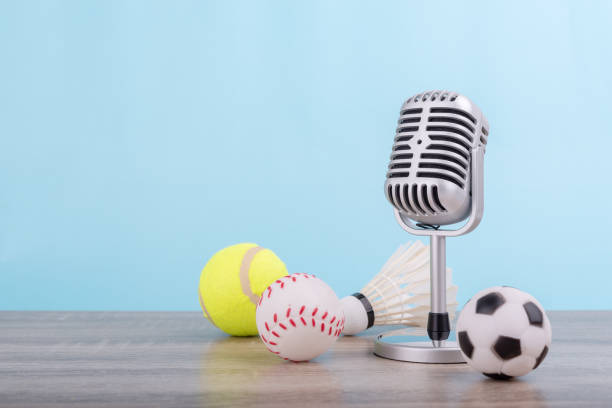 concept sports commentator : the retro microphone put on the wooden table with football or soccer , tennis ball , baseball and shuttlecock isolated on blue background - disco ball fotos imagens e fotografias de stock