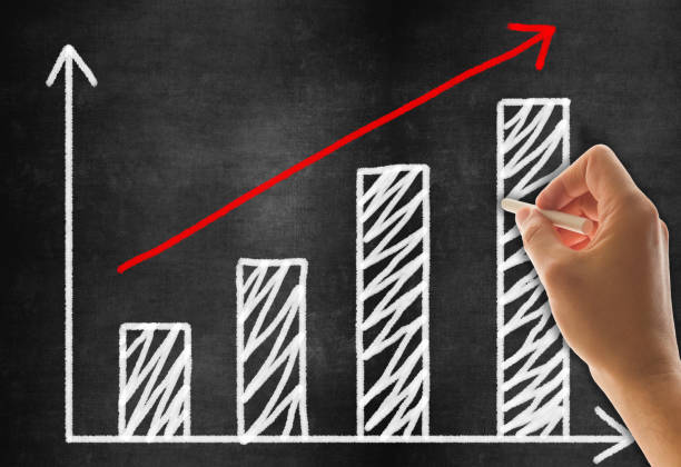 istock Hand Drawing Business Graph on Blackboard Background 1199029835