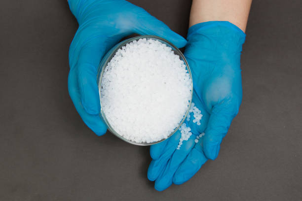 istock Plastic granules . Polypropylene, polyethylene pellets in hands with gloves. Quality control of plastic in the laboratory in production 1199030026