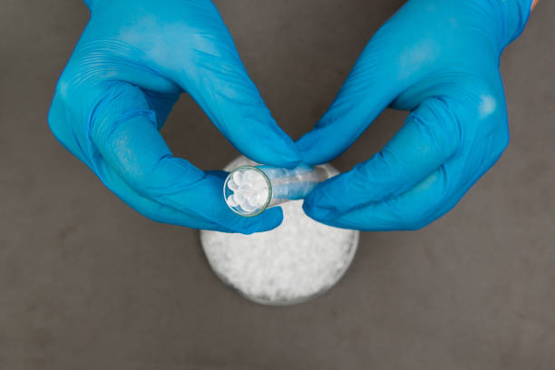 istock Plastic granules . Polyethylene pellets and hands with gloves. Quality control of plastic in the laboratory in production. BPA FREE. 1199033281