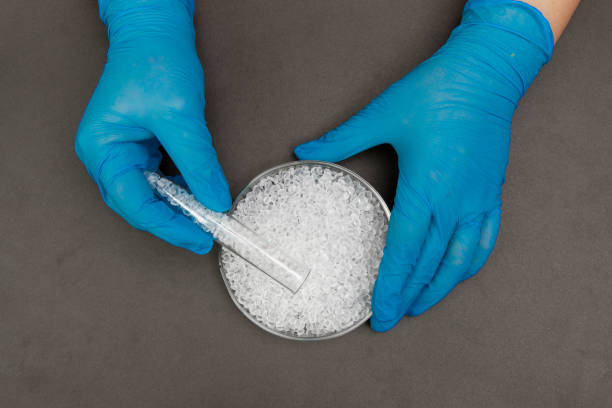 istock Plastic granules . Polyethylene pellets and hands with gloves. Quality control of plastic in the laboratory in production. BPA FREE. 1199033408