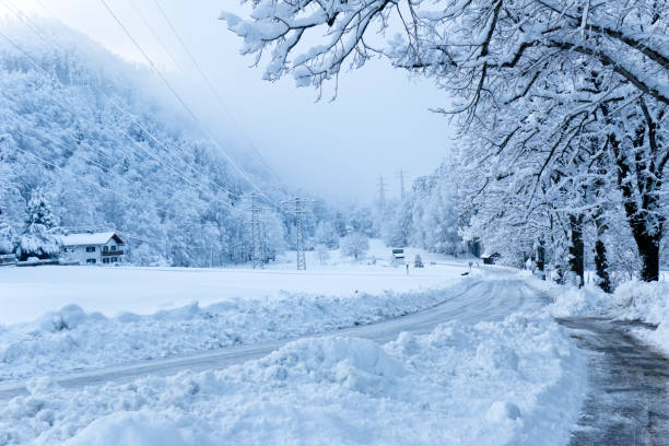 Snowy and icy country road near a mountain village