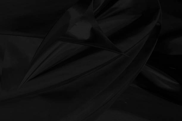 istock soft fabric abstract silky smooth curve decorative black background. Textile sharpen modern style full frame 1199034504