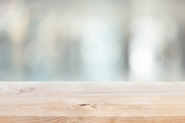 istock Wood table top on blur window glass,wall background 1199035830