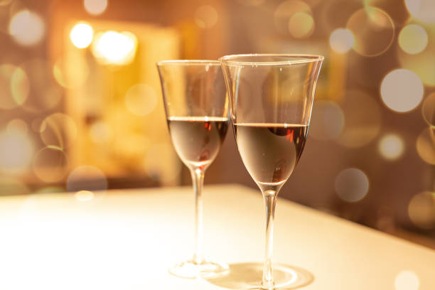 istock Two glasses of red wine in a cozy interior 1199036857