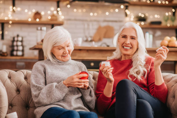 istock Two grey-haired pleasant cute ladies discusing new anti-aging creams 1199037506