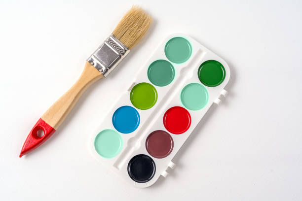 istock Paints in a box and big brush, isolated on white background 1199038617