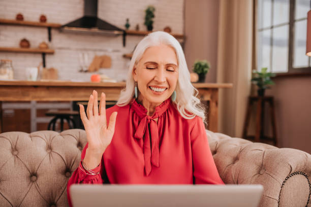 istock Long-haired beautiful lady in red blouse waving her hand 1199038625