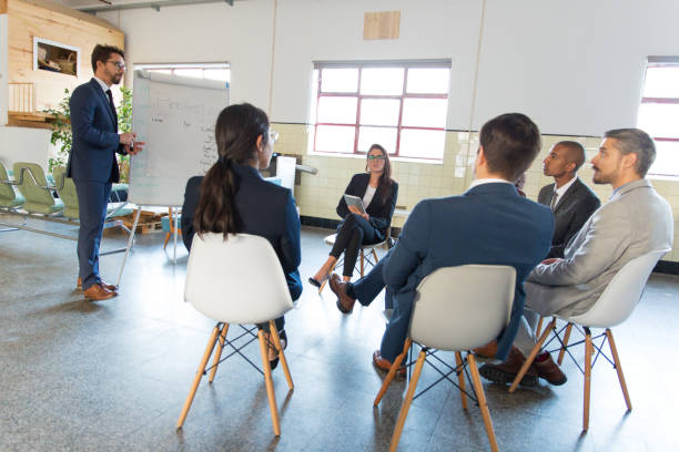 istock Tilted view of thoughtful speaker standing near whiteboard 1199039053