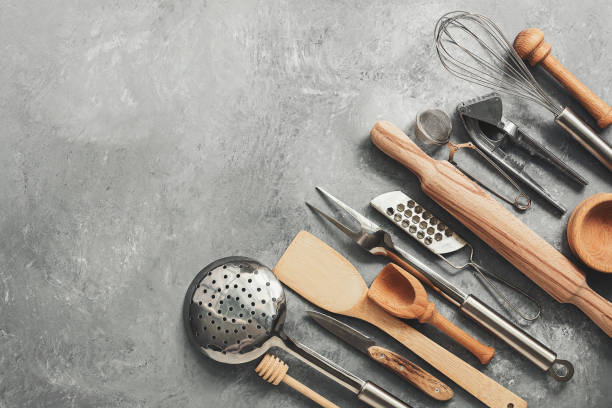 istock A variety of kitchen utensils and tools on a gray concrete rustic background. Top view, flat lay, copy space. 1199039236