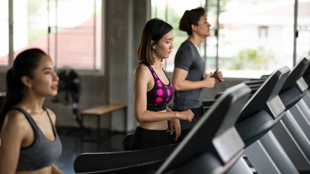 istock running exercise on treadmills at gym 1199040977