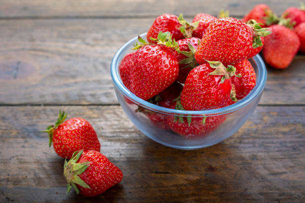 istock fresh strawberries in a plate on a brown wooden background 1199041141