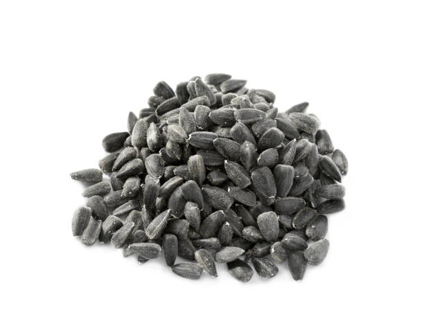 istock Sunflower black seeds pile isolated on white 1199041859