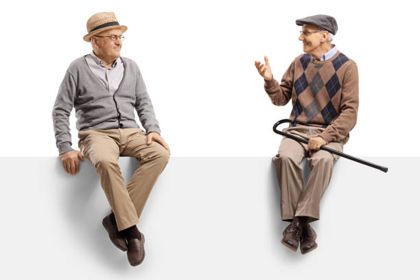 istock Two male pensioners sitting on a panel and talking 1199041992