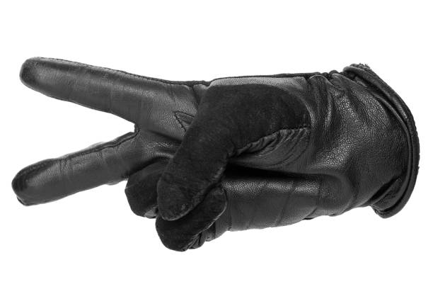istock a hand in a black leather glove shows two fingers that mean peace 1199042425
