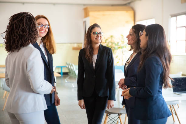 istock Group of smiling female managers talking in open space office 1199044363