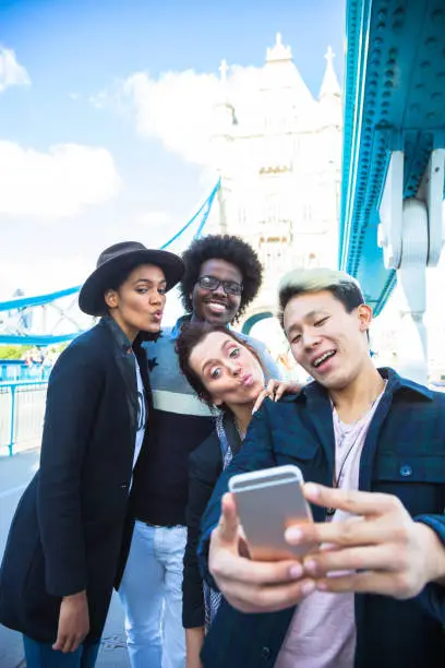 Multi ethnic group of friends taking a selfie with BigBen in Central London