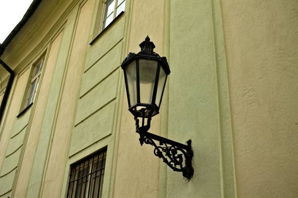 An antique street lamp in front of St.Nicolas Church in the old town of Prague, Czech Republic. Clear blue sky is the background. Shot with Nikon D800 VR28~300mm. Focal length is 62mm, aperture is f22. Shutter speed is 1/200 sec.