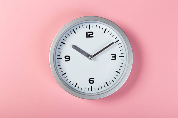 istock minimalistic white wall clock with light metal on a pink background. time concept. 1199046535