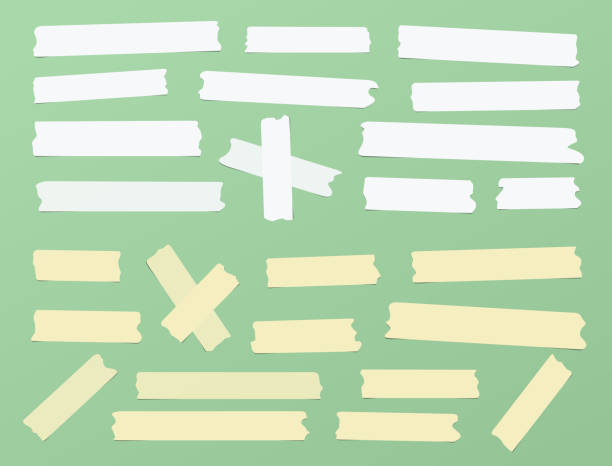 istock Pieces of different size, color, sticky, adhesive masking tape are on green background 1199046652