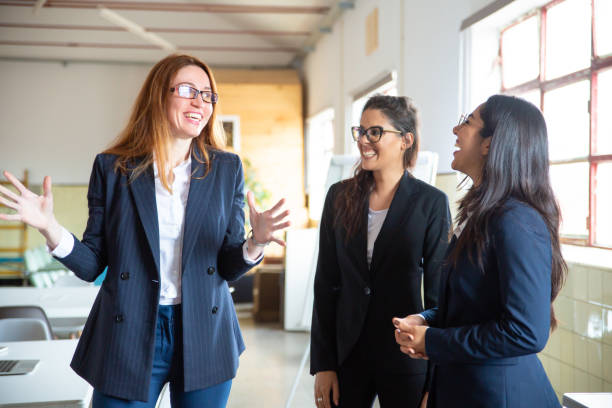 istock Excited redhead young employee talking with colleagues 1199046674